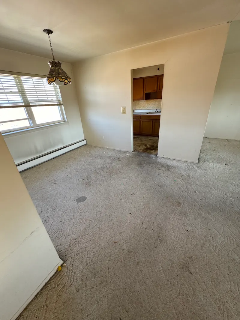 After photo of the same apartment room completely empty, swept, and clear of all boxes and clutter following a JunkDoctors full-service hauling.
