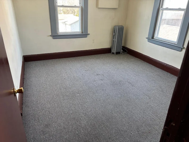 A cleared bedroom in a Jersey City, North Jersey home after JunkDoctors removed old mattresses.