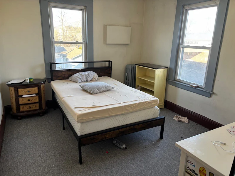 Old mattresses in a Jersey City, North Jersey bedroom before being disposed of by JunkDoctors.