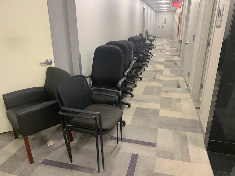 A Morristown, North New Jersey commercial office space filled with chairs and furniture before a JunkDoctors commercial cleanout.