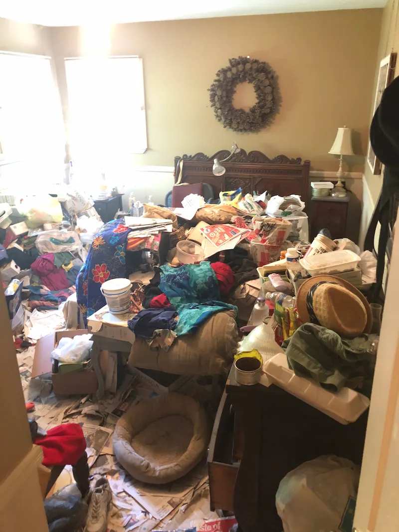 Extreme hoarding conditions in a Highland Park, New Jersey bedroom before a Junk Doctors specialist cleanout.