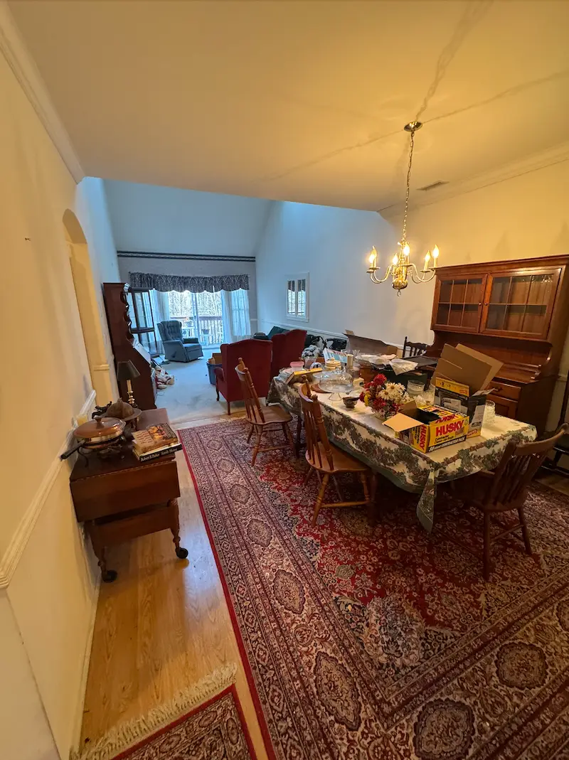 A Morristown, North Jersey residential living room filled with heavy clutter and household items before a full cleanout by JunkDoctors.