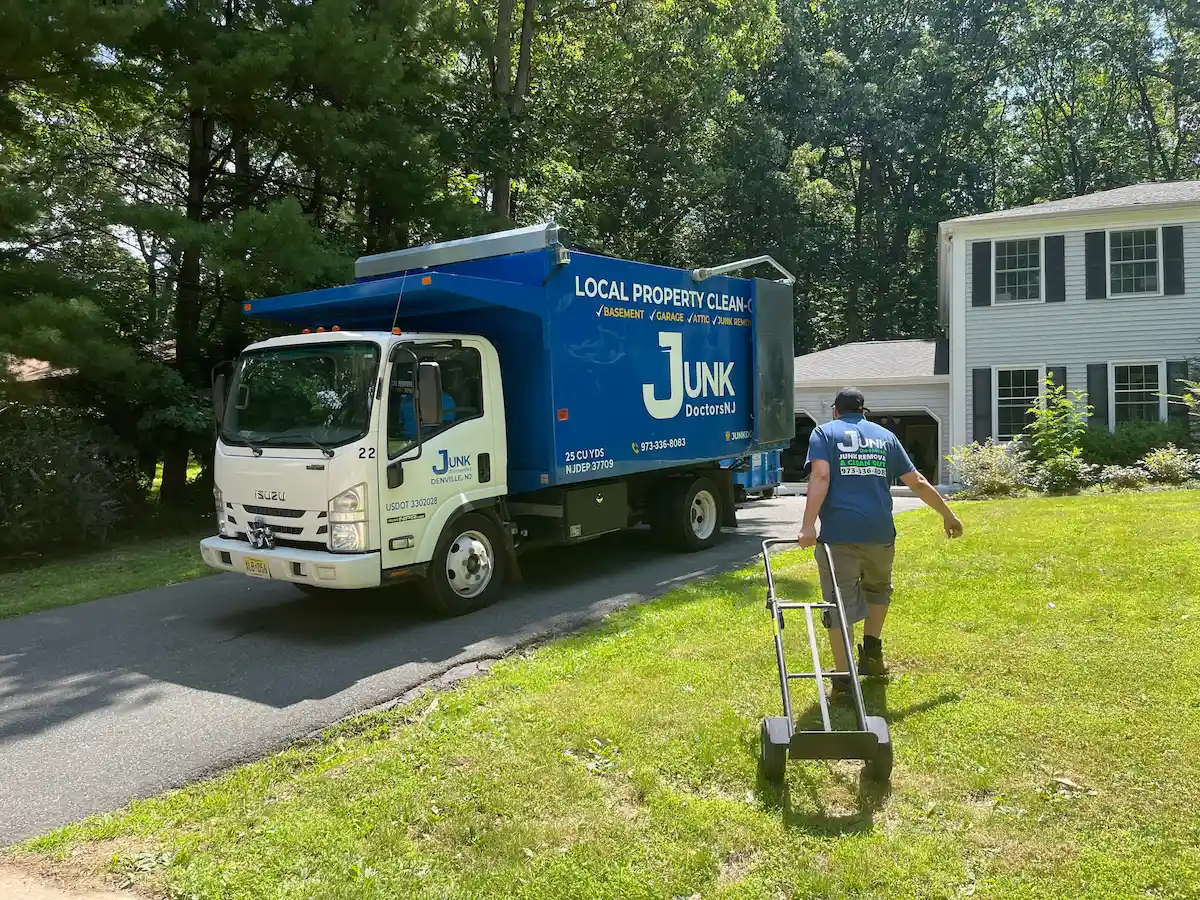 Junk Doctors NJ professional crew member with a dolly approaching a residential home for a full house cleanout and junk removal service.