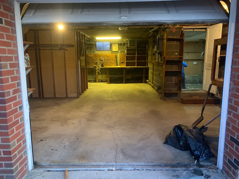 A completely clean, empty, and swept residential garage in Hasbrouck Heights, New Jersey following a professional household junk and clutter removal service by JunkDoctors.