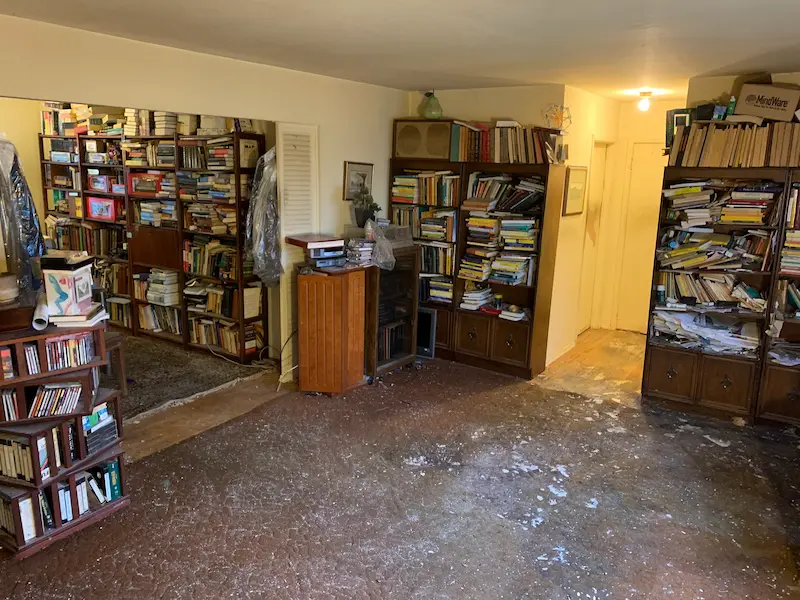 After photo of a partial hoarding cleanout in Marlboro, NJ where Junk Doctors cleared all floor debris and trash while carefully preserving the client's book and media collections.