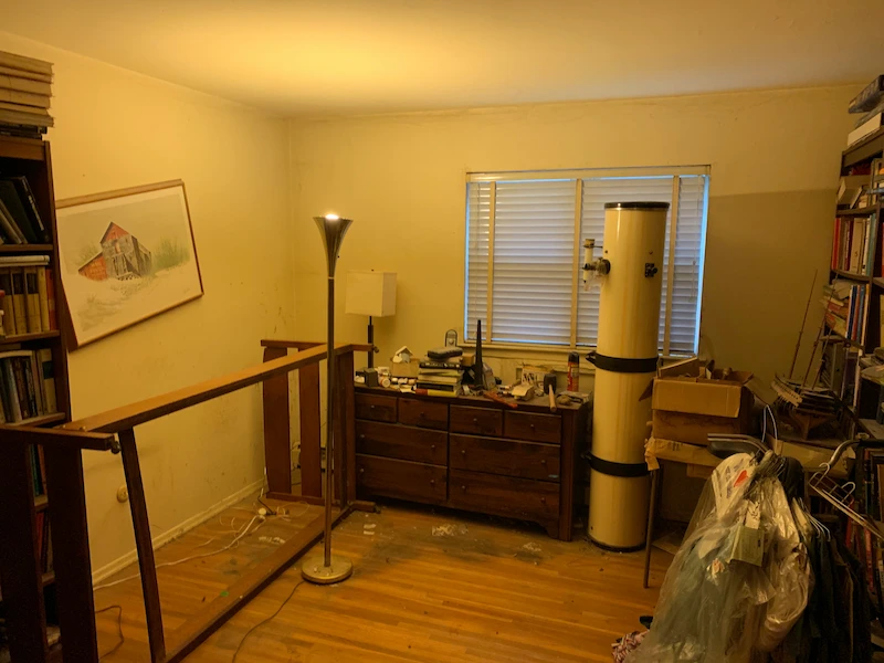 The Hackettstown, New Jersey bedroom after a partial hoarding cleanout, showing cleared floor space and organized furniture per client instructions.