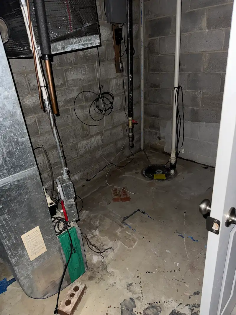 A North Jersey basement utility area fully cleared of debris, providing safe access to the HVAC system and sump pump.