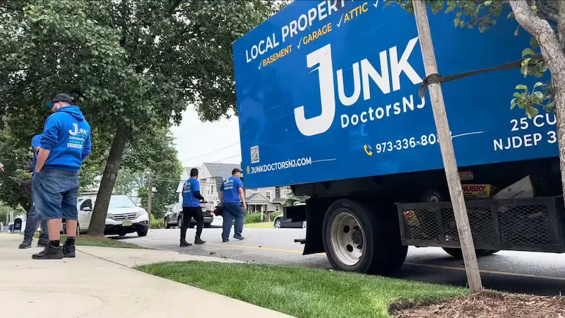JunkDoctors truck parked outside a home for a cleanout.